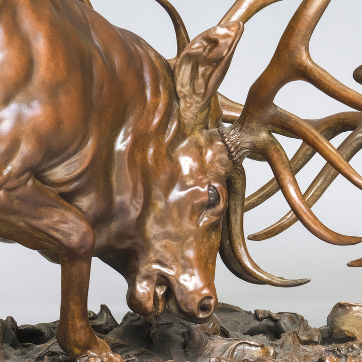 Bronze sculpture of two red deer stags in mid-rut, antlers locked in a dynamic head-to-head clash, highly detailed musculature and patina, mounted on a textured bronze base.
