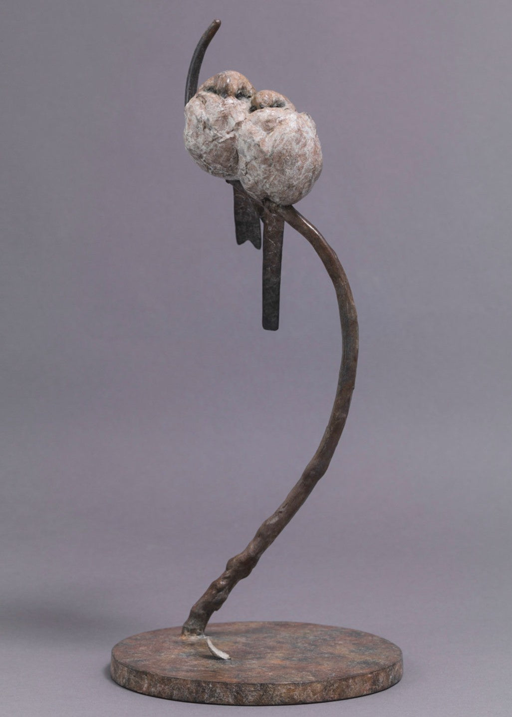 A delicate bronze sculpture of two long-tailed tits nestled together on a sweeping branch, their rounded forms and soft patinated tones capturing warmth, intimacy and the gentle character of these much-loved British birds.