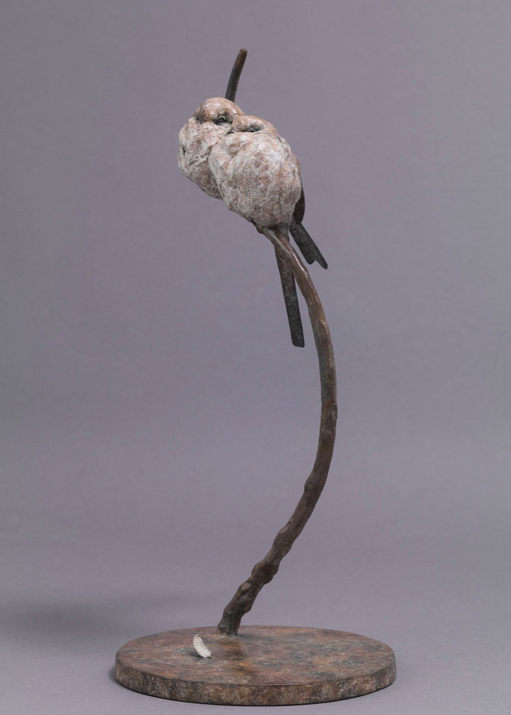 A delicate bronze sculpture of two long-tailed tits nestled together on a sweeping branch, their rounded forms and soft patinated tones capturing warmth, intimacy and the gentle character of these much-loved British birds.