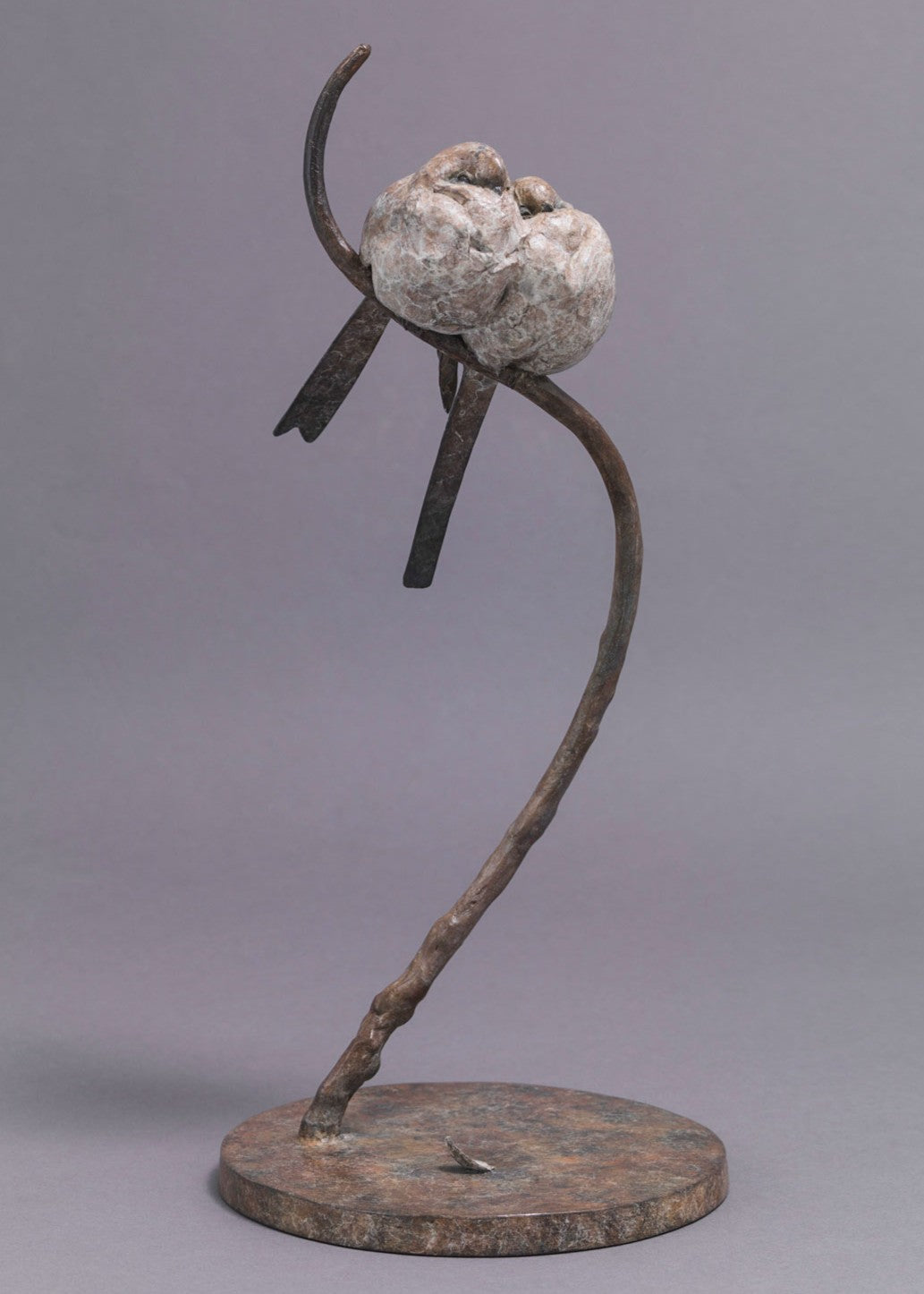 A delicate bronze sculpture of two long-tailed tits nestled together on a sweeping branch, their rounded forms and soft patinated tones capturing warmth, intimacy and the gentle character of these much-loved British birds.