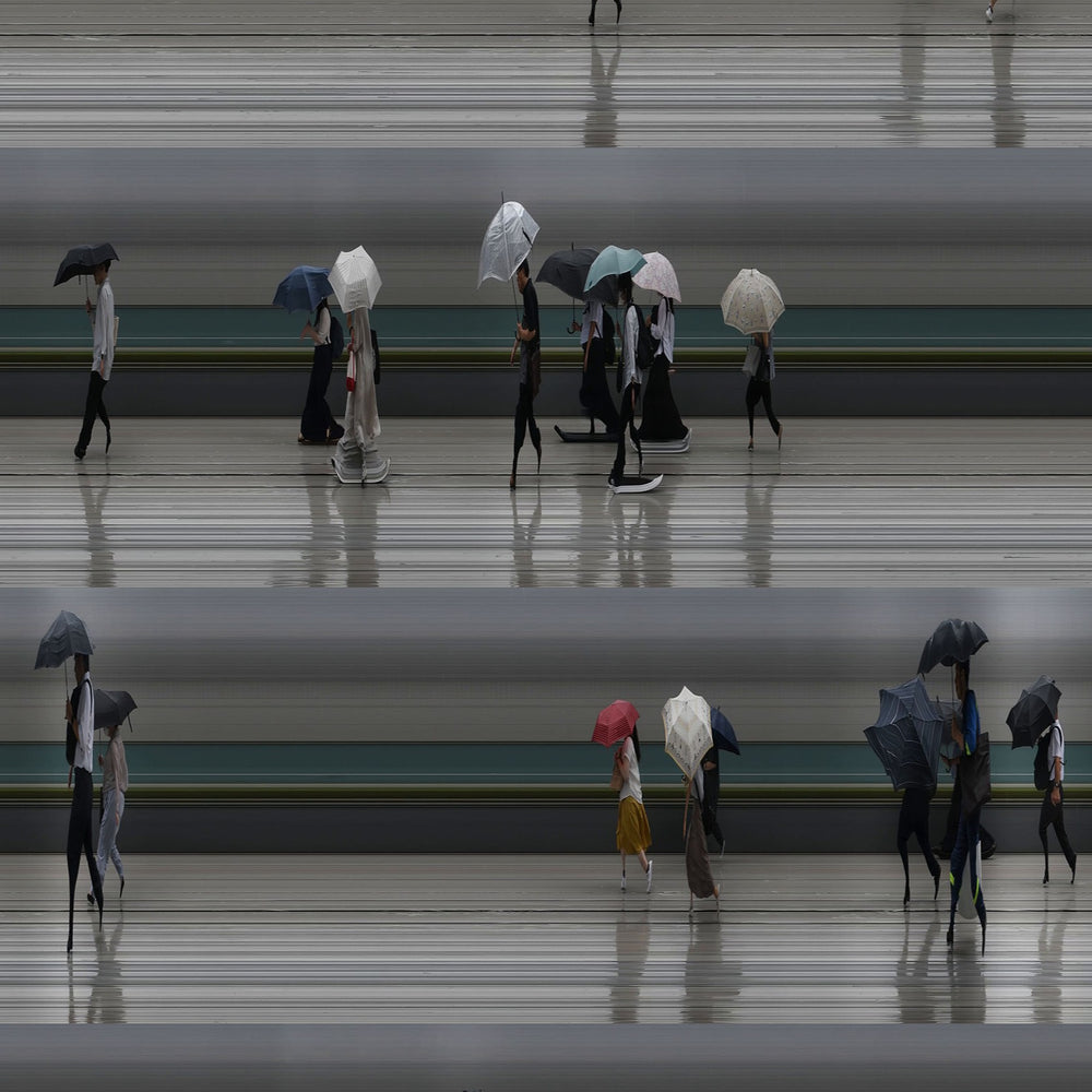 Richard P Jones Tokyo Summer Storm #1 fine art photographic print showing rows of commuters walking with umbrellas during heavy rain in Tokyo, created from reconstructed high-speed video imagery and printed as a giclée on brushed aluminium.