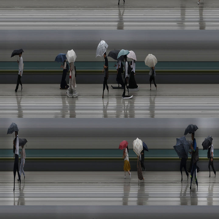 Richard P Jones Tokyo Summer Storm #1 fine art photographic print showing rows of commuters walking with umbrellas during heavy rain in Tokyo, created from reconstructed high-speed video imagery and printed as a giclée on brushed aluminium.