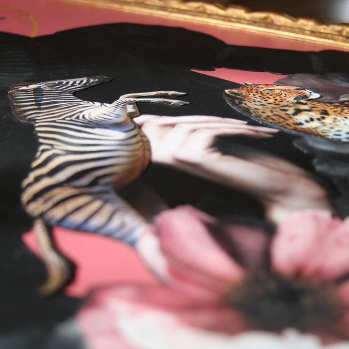 Catarina Diaz’s Transcendence, analogue collage on Somerset Enhanced Velvet with oil on canvas. A pale-haired figure in black ruff, crowned with flowers, zebra, leopard and crowned crane, set against a pink backdrop with gold halo in ornate antique frame.