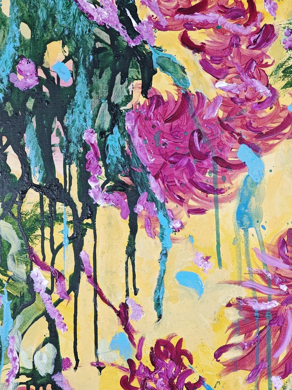 Vivid abstract painting with bold magenta florals, dripping green strokes, and splashes of blue over a bright yellow background
