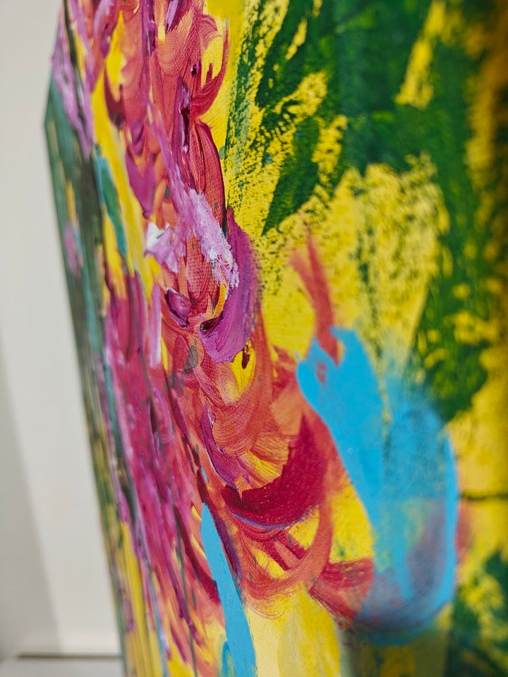 Vivid abstract painting with bold magenta florals, dripping green strokes, and splashes of blue over a bright yellow background