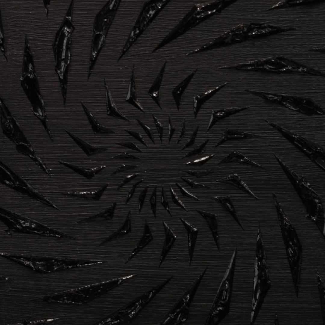 Black-on-black contemporary wall artwork by Mike Philp with angular geometric forms spiralling inward across a dark ground. Subtle texture and shadow create depth, movement, and quiet intensity.