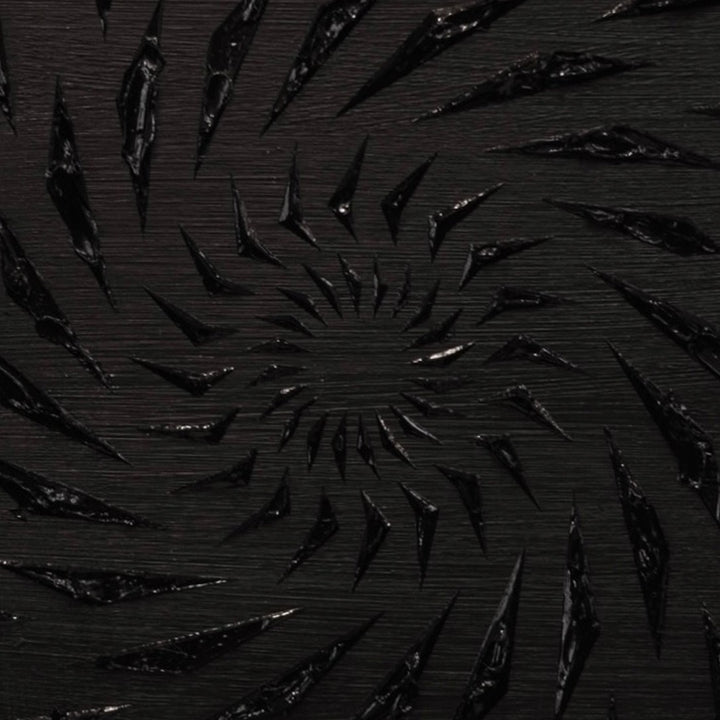 Black-on-black contemporary wall artwork by Mike Philp with angular geometric forms spiralling inward across a dark ground. Subtle texture and shadow create depth, movement, and quiet intensity.