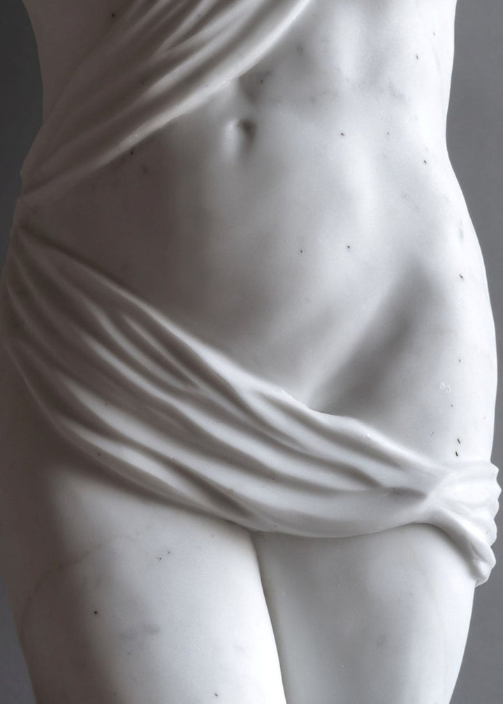 Lucy Unwin marble sculpture Venus, hand carved from white Statuary Carrara marble, depicting a contemporary female torso partially wrapped in flowing carved drapery with smooth figurative contours and finely detailed folds.