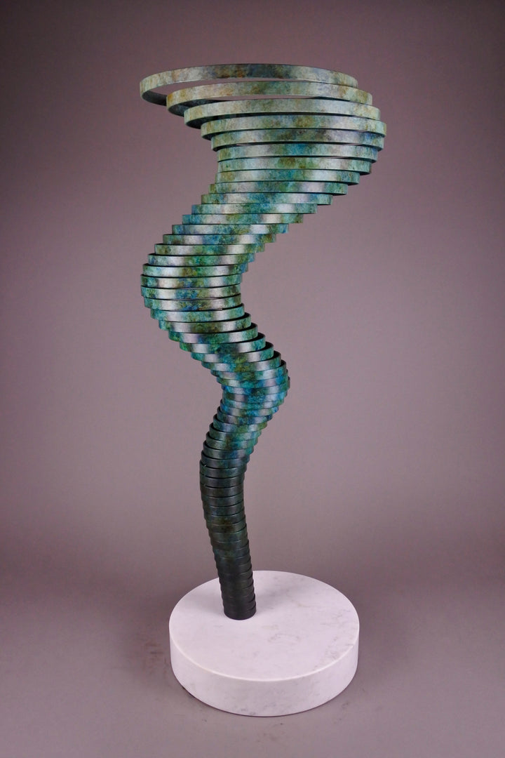 Vortex II by Thomas Joynes – a limited edition bronze sculpture with artisan patina, exploring Fibonacci-based forms through stacked, spiralling discs. The rich verdigris patina in green-blue and rust tones highlights the rhythmic, wave-like movement of the bronze layers. Mounted on a smooth Carrara marble base, the piece brings a sense of elegance and kinetic energy to any contemporary interior.