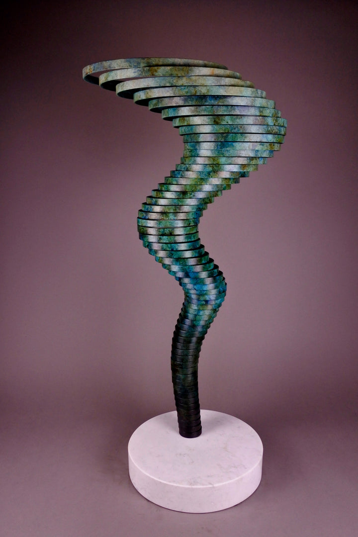 Vortex II by Thomas Joynes – a limited edition bronze sculpture with artisan patina, exploring Fibonacci-based forms through stacked, spiralling discs. The rich verdigris patina in green-blue and rust tones highlights the rhythmic, wave-like movement of the bronze layers. Mounted on a smooth Carrara marble base, the piece brings a sense of elegance and kinetic energy to any contemporary interior.