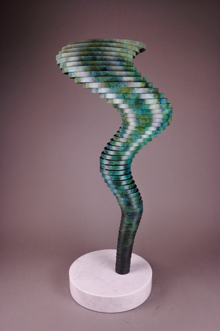 Vortex II by Thomas Joynes – a limited edition bronze sculpture with artisan patina, exploring Fibonacci-based forms through stacked, spiralling discs. The rich verdigris patina in green-blue and rust tones highlights the rhythmic, wave-like movement of the bronze layers. Mounted on a smooth Carrara marble base, the piece brings a sense of elegance and kinetic energy to any contemporary interior.