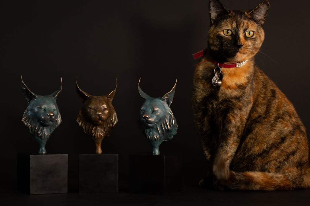 Wee Petra Eurasian Lynx bronze sculpture by Min Reed, miniature lynx head with closed eyes and elegant ear tufts in green verdigris bronze with warm copper highlights, mounted on a small black plinth, contemporary wildlife bronze sculpture