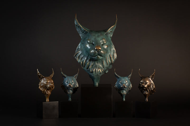 Wee Petra Eurasian Lynx bronze sculpture by Min Reed, miniature lynx head with closed eyes and elegant ear tufts in green verdigris bronze with warm copper highlights, mounted on a small black plinth, contemporary wildlife bronze sculpture