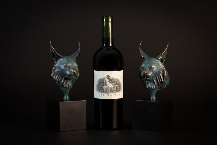 Wee Petra Eurasian Lynx bronze sculpture by Min Reed, miniature lynx head with closed eyes and elegant ear tufts in green verdigris bronze with warm copper highlights, mounted on a small black plinth, contemporary wildlife bronze sculpture