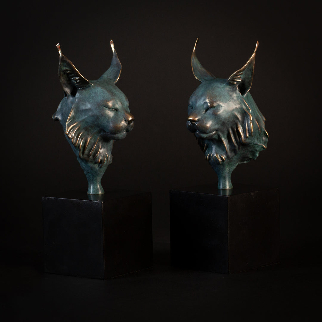Wee Petra Eurasian Lynx bronze sculpture by Min Reed, miniature lynx head with closed eyes and elegant ear tufts in green verdigris bronze with warm copper highlights, mounted on a small black plinth, contemporary wildlife bronze sculpture