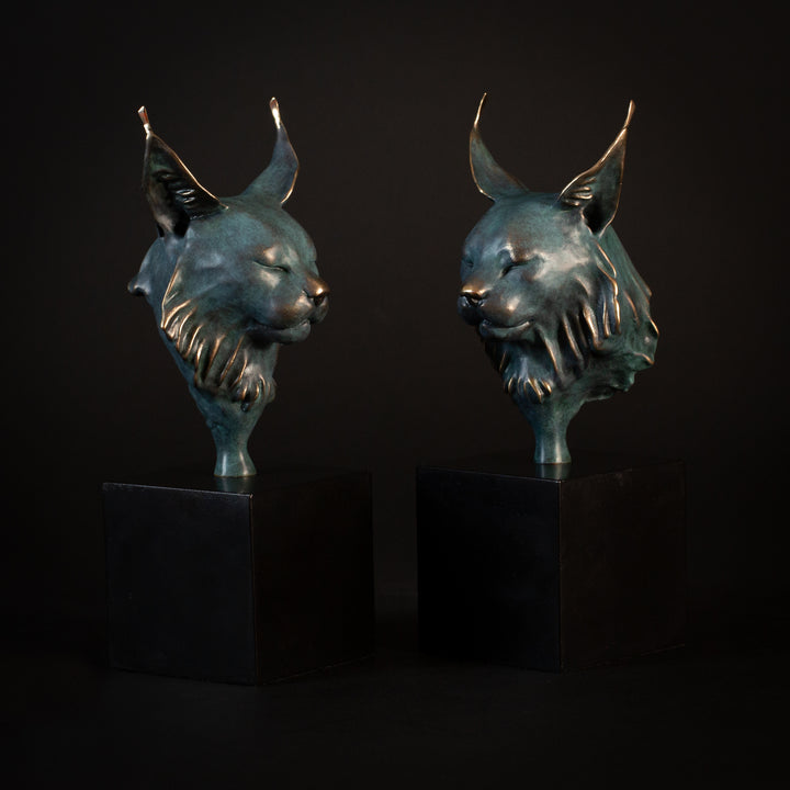 Wee Petra Eurasian Lynx bronze sculpture by Min Reed, miniature lynx head with closed eyes and elegant ear tufts in green verdigris bronze with warm copper highlights, mounted on a small black plinth, contemporary wildlife bronze sculpture