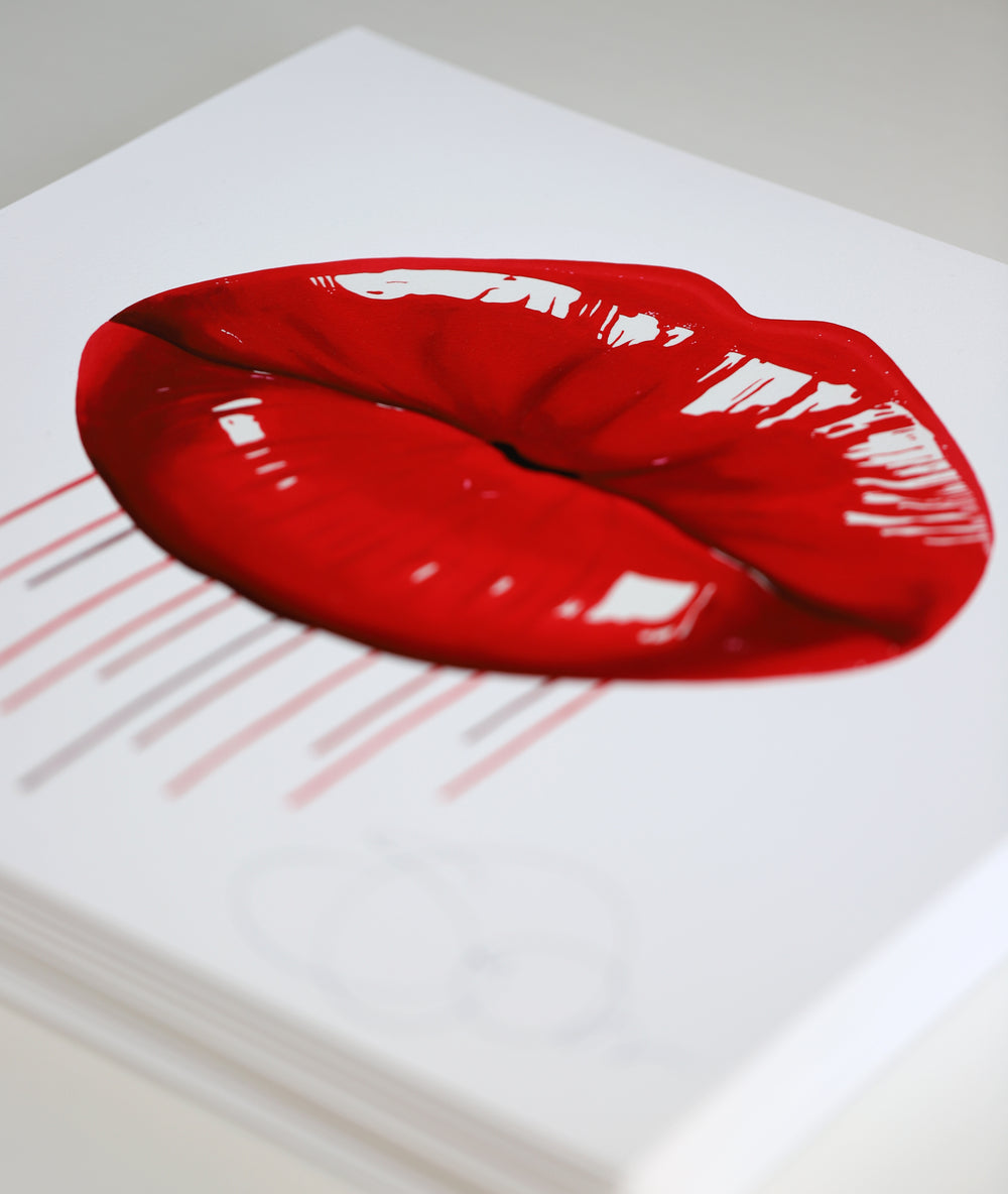 Glossy red lips with vertical paint drips on a clean white background.
