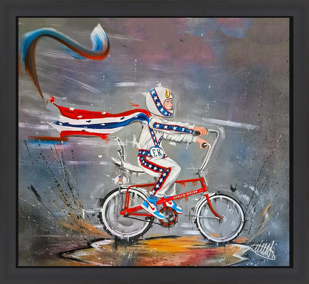 Original painting “Kid Knievel” by Wild Seeley — a dynamic urban artwork of a young stunt rider in a red, white, and blue Evel Knievel–style suit and helmet, speeding on a vintage Apollo Racer bicycle with flowing cape against a gritty, textured background.