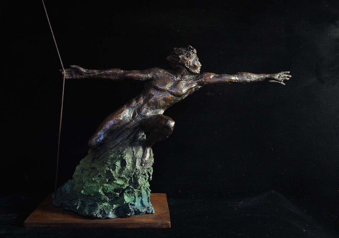 Bronze figurative sculpture by Eve Shepherd showing a dynamic human figure lunging forward with outstretched arms, balanced on a textured base, capturing tension, desire, and suspended movement against a dark background.