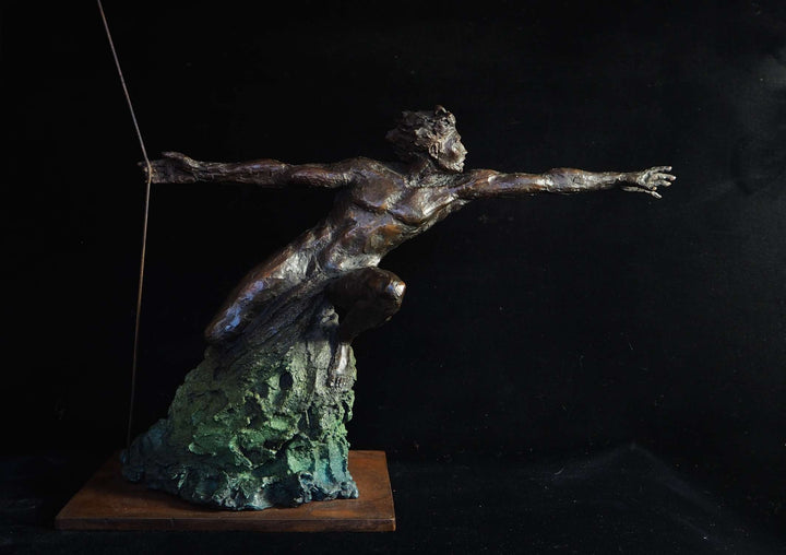 Bronze figurative sculpture by Eve Shepherd showing a dynamic human figure lunging forward with outstretched arms, balanced on a textured base, capturing tension, desire, and suspended movement against a dark background.