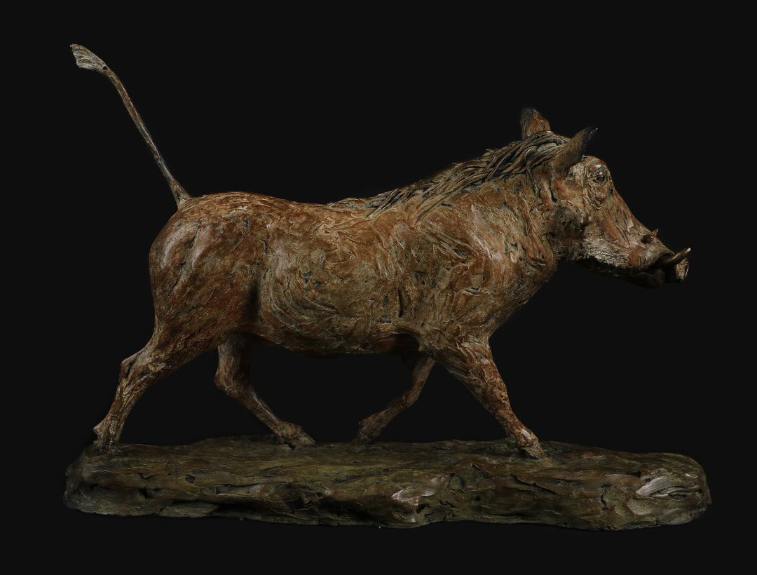 Bronze sculpture of a warthog mid-stride, with textured surface detailing and raised tail, mounted on a naturalistic base