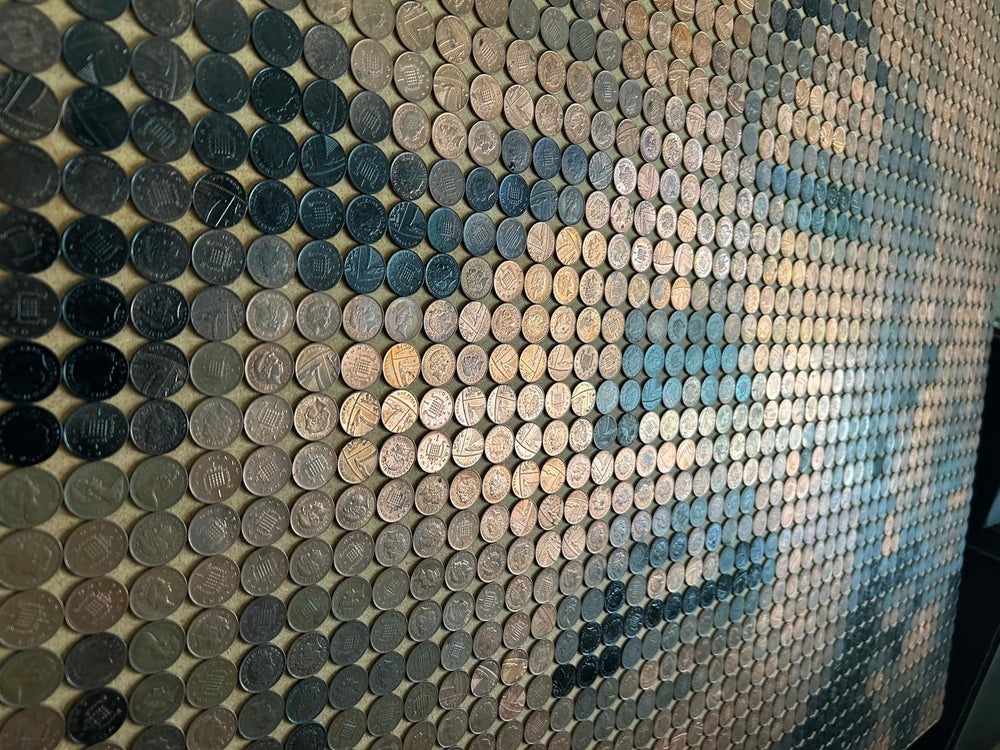 Ed Chapman mosaic portrait of Marilyn Monroe created from 2,301 one penny coins, forming a shimmering likeness through copper, bronze, and dark patina tones, a striking pop culture artwork blending currency and fine art.