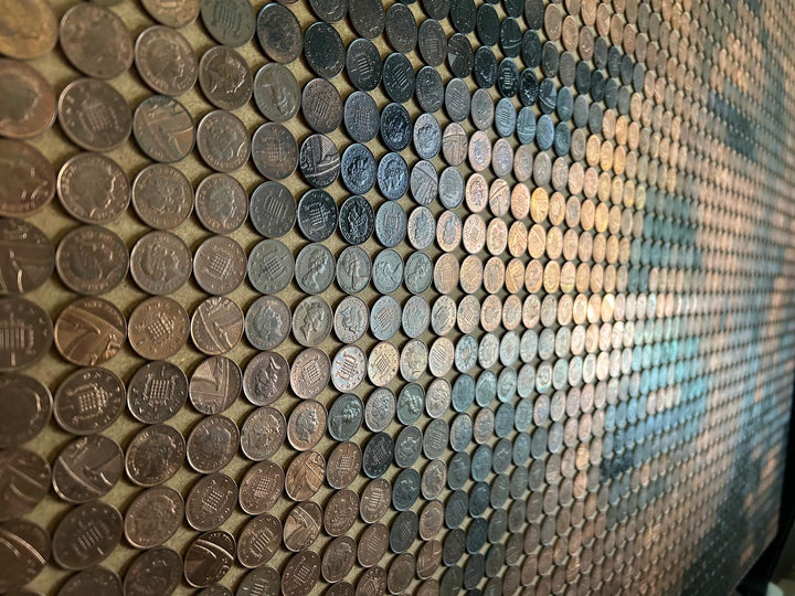 Ed Chapman mosaic portrait of Marilyn Monroe created from 2,301 one penny coins, forming a shimmering likeness through copper, bronze, and dark patina tones, a striking pop culture artwork blending currency and fine art.