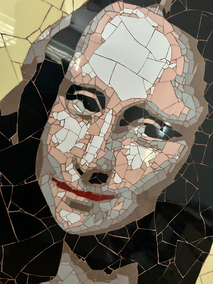 Ed Chapman Mosaic portrait of the Mona Lisa constructed from precisely cut ceramic tiles, with angular fragments forming the face, hair and clothing through subtle tonal shifts, set against a bold yellow background and creating a structured, tactile surface with visible tile joins and rhythmic patterning.