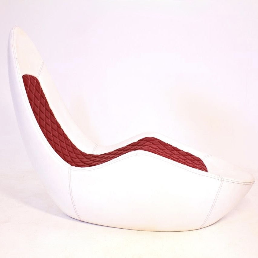 “Caillou Chaise – Leather” by Ben Rousseau – a sculptural chaise in white leather with quilted red stitching, inspired by automotive interiors. Handcrafted in composite with full leather upholstery, merging comfort, craftsmanship, and design.

