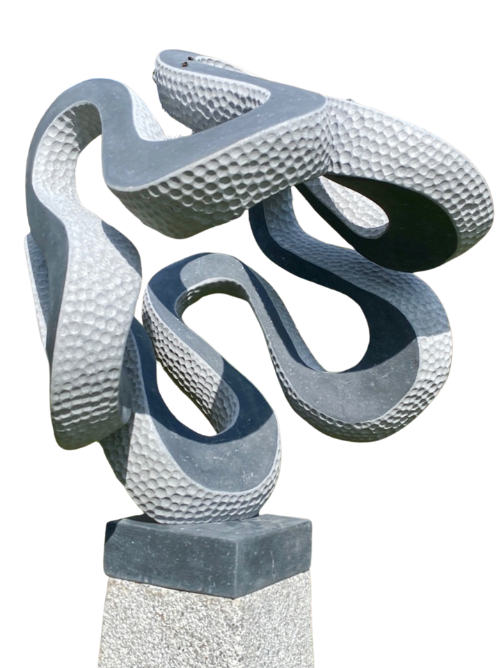 Abstract stone sculpture Wiggle – 2025 by Hamish Holman, carved in dark grey Kilkenny limestone with an interwoven looping form, combining smooth flowing curves with textured hand-carved dimples, dynamic and playful, mounted on a stone plinth.