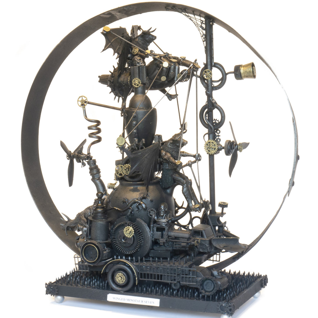 “Winged Minotaur VII” by Andrew Stevens – a one-off steampunk sculpture fusing myth and machinery. Crafted from recycled car parts, brass gears and found materials, finished in dark bronze patina with intricate mechanical detail and winged figures.