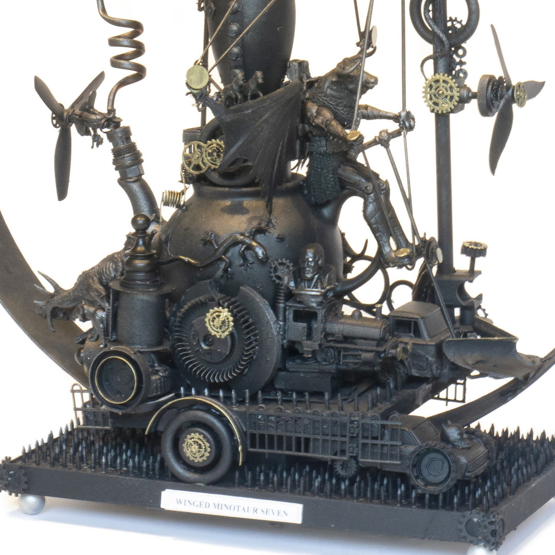 “Winged Minotaur VII” by Andrew Stevens – a one-off steampunk sculpture fusing myth and machinery. Crafted from recycled car parts, brass gears and found materials, finished in dark bronze patina with intricate mechanical detail and winged figures.