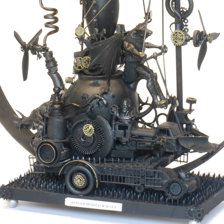 “Winged Minotaur VII” by Andrew Stevens – a one-off steampunk sculpture fusing myth and machinery. Crafted from recycled car parts, brass gears and found materials, finished in dark bronze patina with intricate mechanical detail and winged figures.