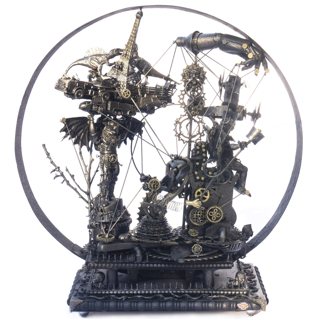 Steampunk-inspired recycled sculpture featuring a winged minotaur form built from broken toys, gears, metal parts and found materials, all finished in a dark bronze patina within a circular frame.