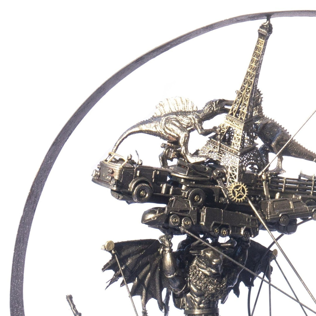 Steampunk-inspired recycled sculpture featuring a winged minotaur form built from broken toys, gears, metal parts and found materials, all finished in a dark bronze patina within a circular frame.