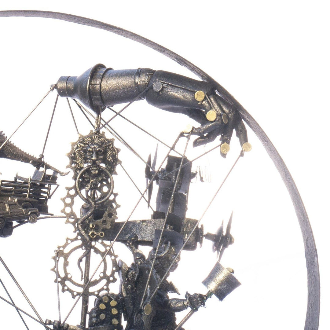 Steampunk-inspired recycled sculpture featuring a winged minotaur form built from broken toys, gears, metal parts and found materials, all finished in a dark bronze patina within a circular frame.