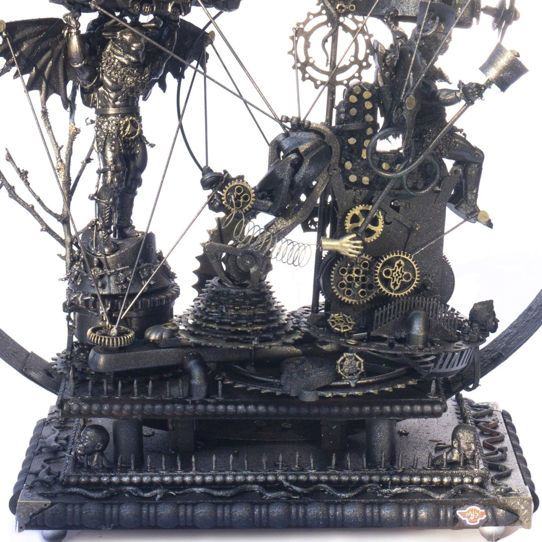 Steampunk-inspired recycled sculpture featuring a winged minotaur form built from broken toys, gears, metal parts and found materials, all finished in a dark bronze patina within a circular frame.