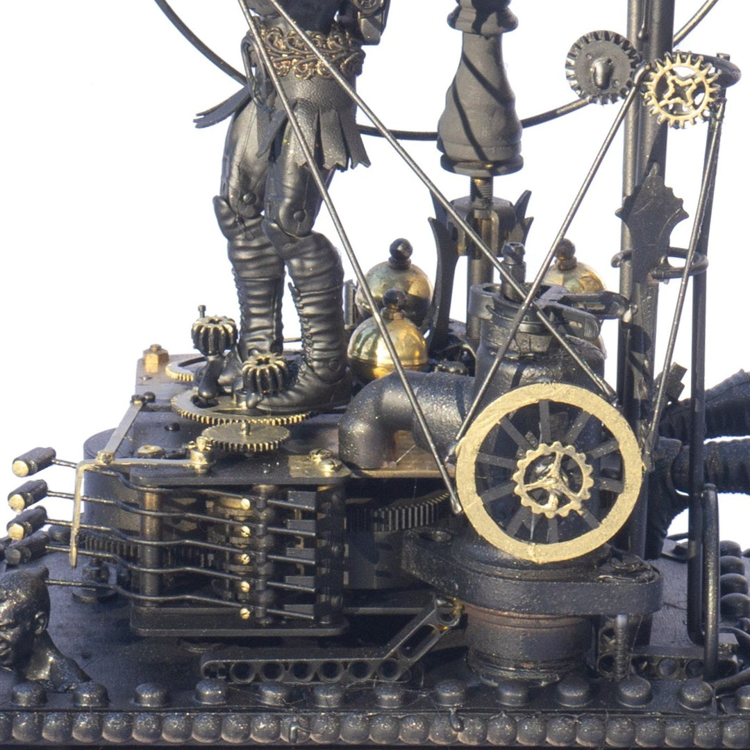 A steampunk sculpture featuring winged minotaur figures assembled from broken toys, brass clock parts, wood offcuts and metal components, all finished in a dark bronze patina. The figures appear in playful motion, including one holding a tennis racket, set on an ornate mechanical base with gears and cogs.
