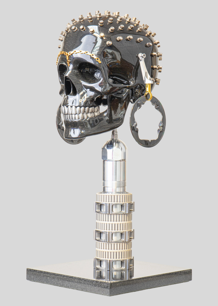 Alastair Gibson CarbonArt45 carbon fibre skull sculpture with high-gloss finish, Formula One components, stainless steel bolt crown detail, gold-plated accents and precision-engineered metal base