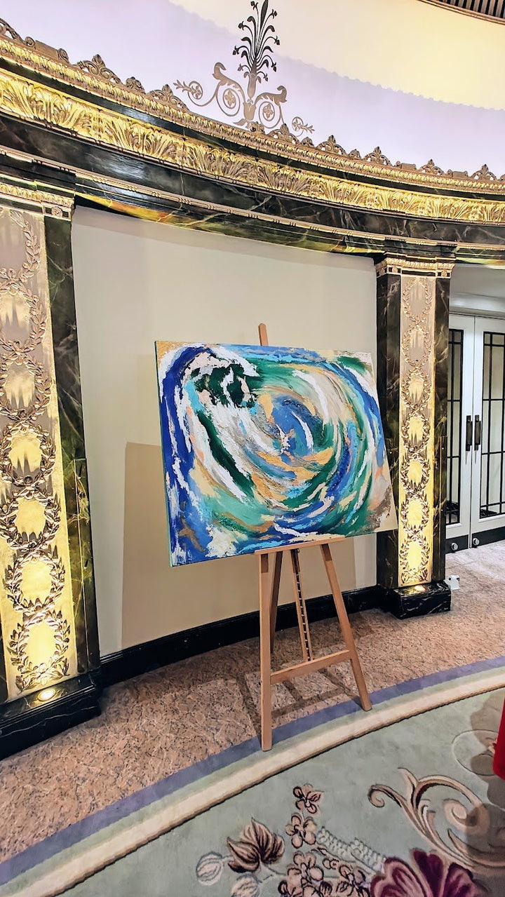 Vibrant abstract painting with swirling strokes of blue, green, white, and gold, evoking the motion of water and natural elements