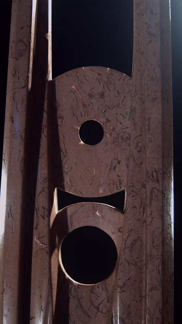 A tall abstract stone sculpture with two inward-facing vertical spires joined at the base, carved in contrasting smooth and textured Purbeck stone, mounted on a dark granite base.