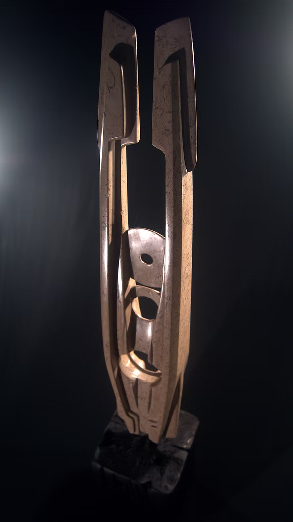 A tall abstract stone sculpture with two inward-facing vertical spires joined at the base, carved in contrasting smooth and textured Purbeck stone, mounted on a dark granite base.