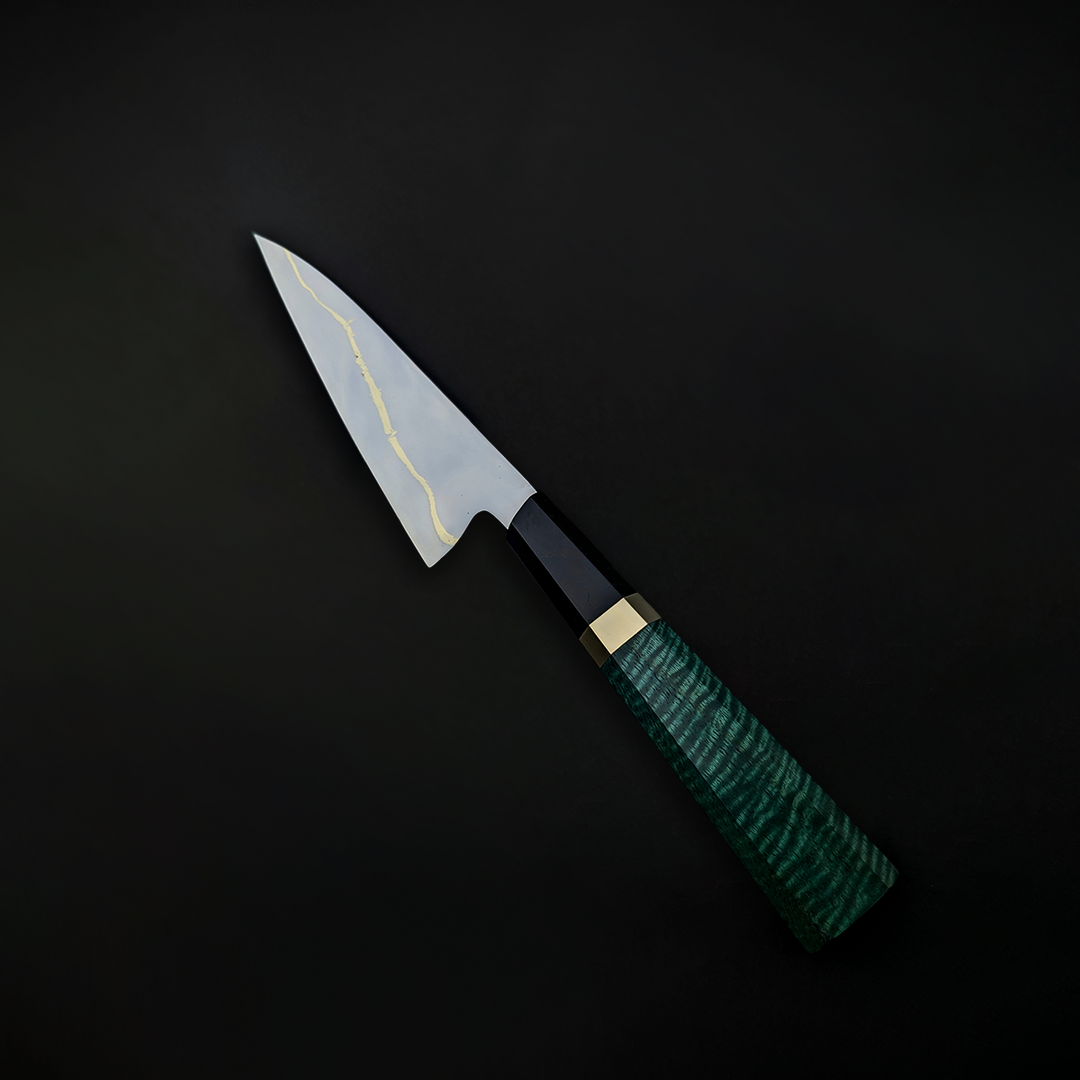 150mm mirror-polished paring knife by Beggs Forgeworks, crafted from Z-Finit stainless alloy with a brass inlay, blackwood ferrule, and curly maple handle in deep green tones—engineered for corrosion resistance and precision cutting.