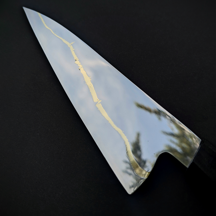 150mm mirror-polished paring knife by Beggs Forgeworks, crafted from Z-Finit stainless alloy with a brass inlay, blackwood ferrule, and curly maple handle in deep green tones—engineered for corrosion resistance and precision cutting.