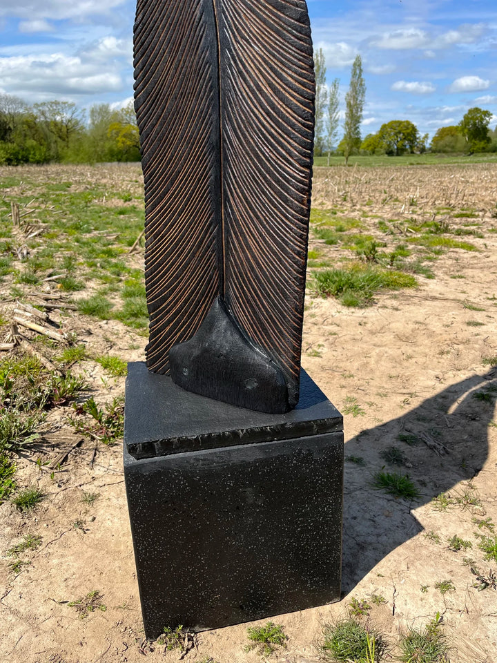 Tall oak sculpture by Glen Farrelly titled Beltane, carved with fine rhythmic grooves and finished using the Yakisugi technique. Charred blackened wood with bronze undertones, symbolising spring, fertility, and renewal.