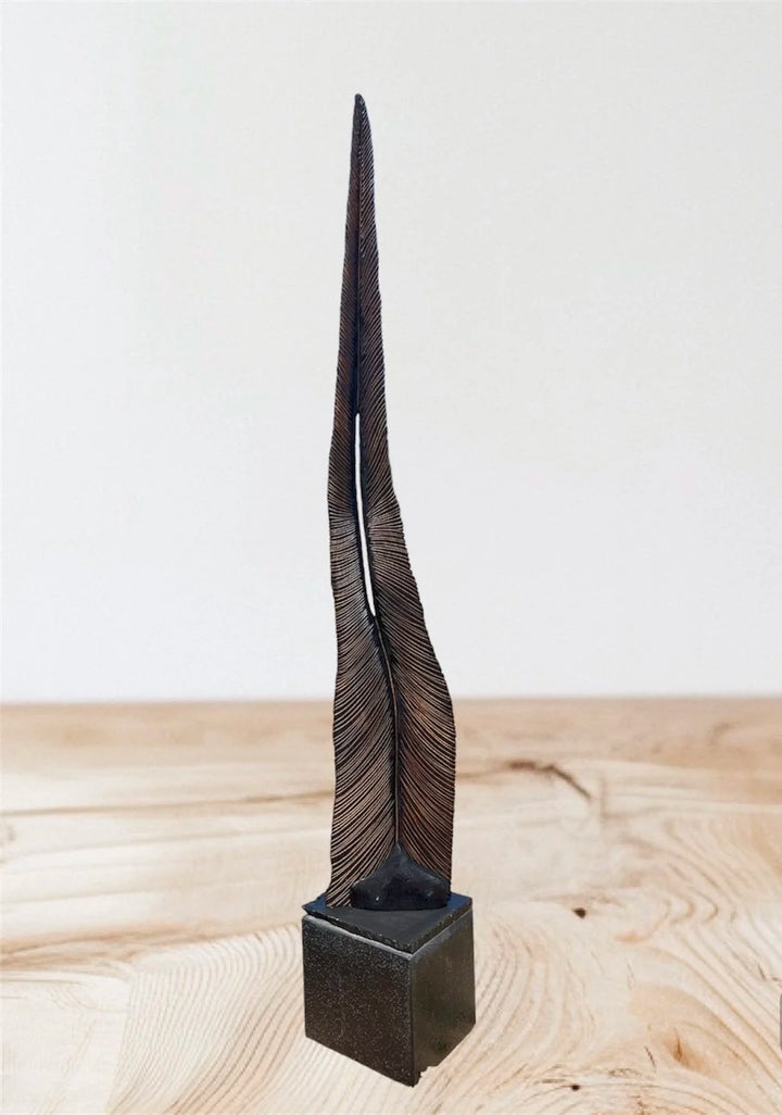 Tall oak sculpture by Glen Farrelly titled Beltane, carved with fine rhythmic grooves and finished using the Yakisugi technique. Charred blackened wood with bronze undertones, symbolising spring, fertility, and renewal.