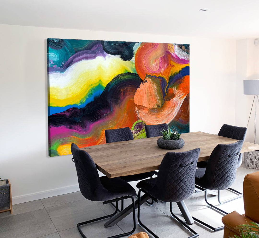 Large vibrant abstract painting “Sun Chaser” by Swarez — a powerful composition of swirling, layered colour featuring vivid yellow bursts cutting across deep oranges, fiery reds, rich magentas, lush greens, electric blues, dark purples and intense black accents. Complex ribbons and rivers of enamel paint create fluid movement and luminous depth on a grand-scale canvas.