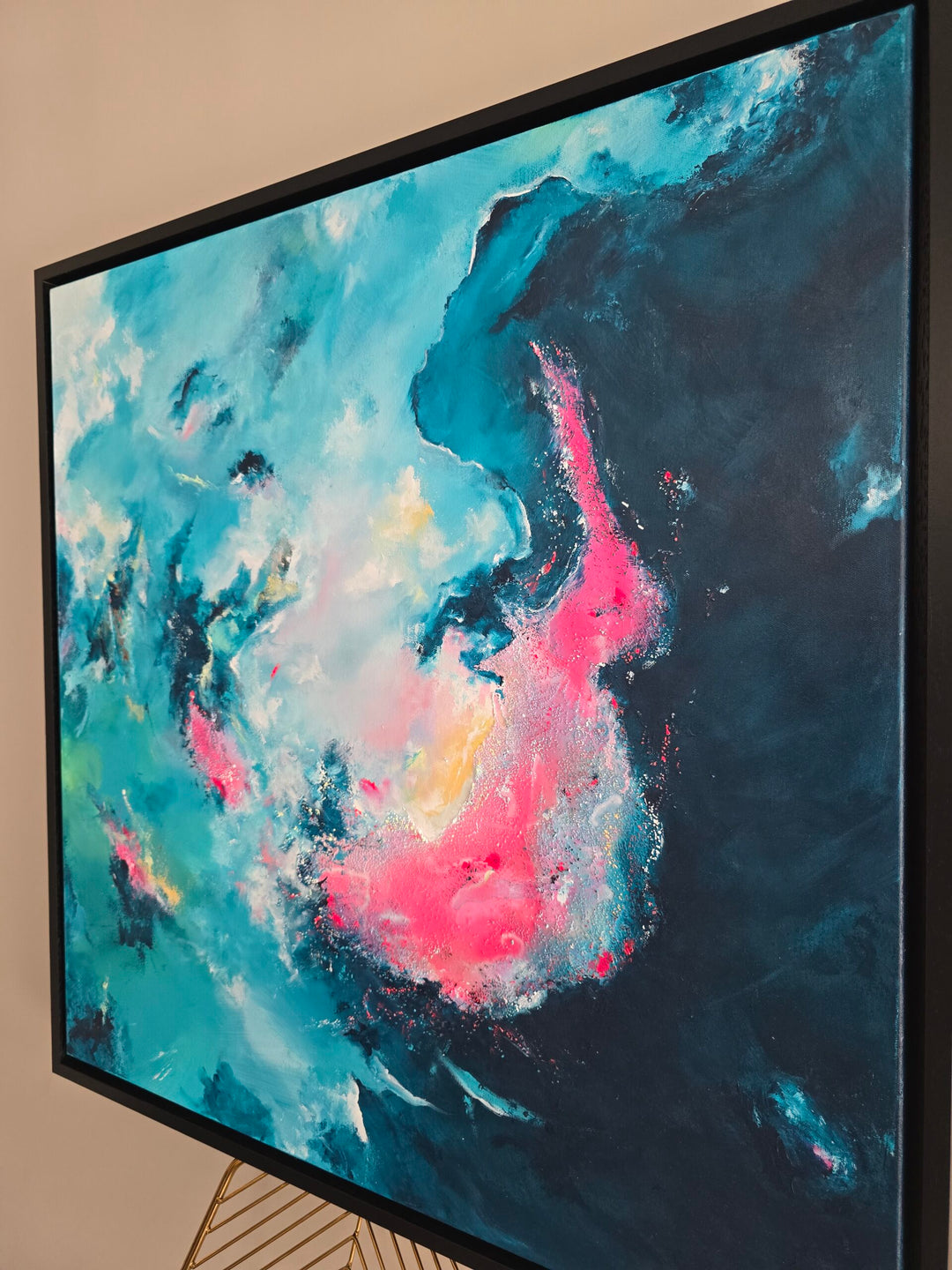An abstract mixed-media painting in vibrant teal, turquoise, deep navy and neon pink, with layered textures and soft airbrushed transitions creating a swirling, cloud-like composition that shifts between calm spaces and energetic bursts of colour.