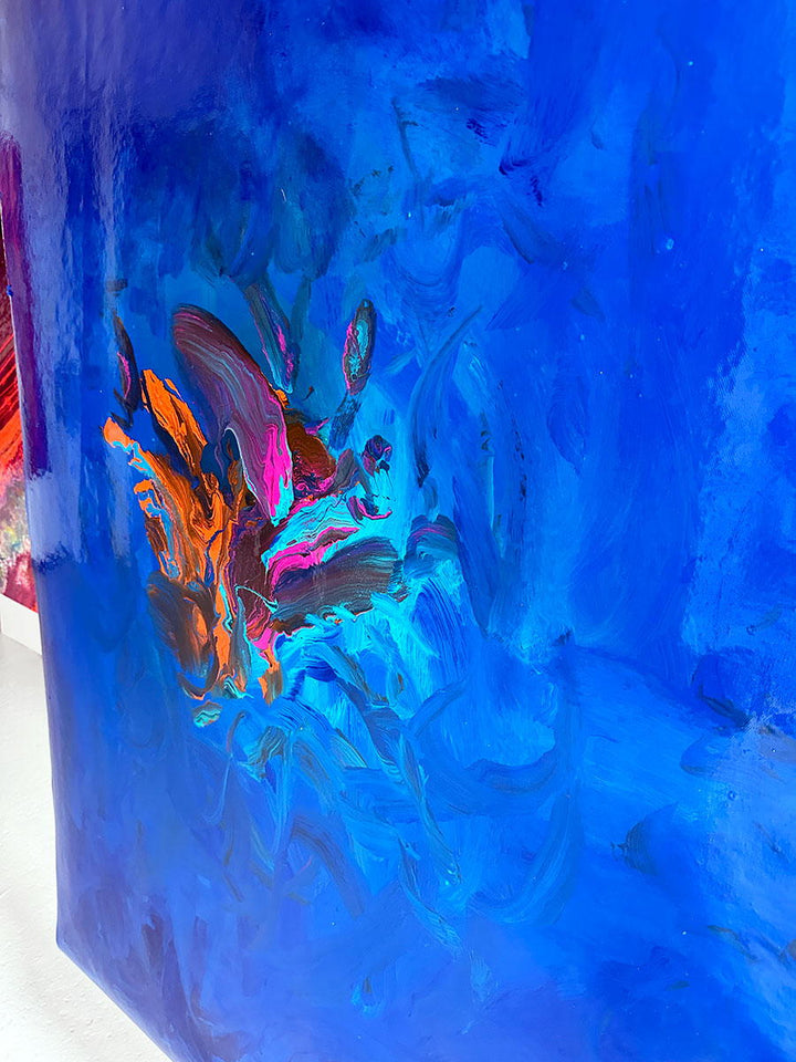Large abstract painting “Into the Blue” by Swarez — deep ocean-inspired composition with layered shades of cobalt, ultramarine, turquoise, and teal blue. Vivid bursts of fiery orange, vibrant fuchsia, aqua, and rich purple emerge in the centre, with swirling, glossy enamel textures creating movement and depth.