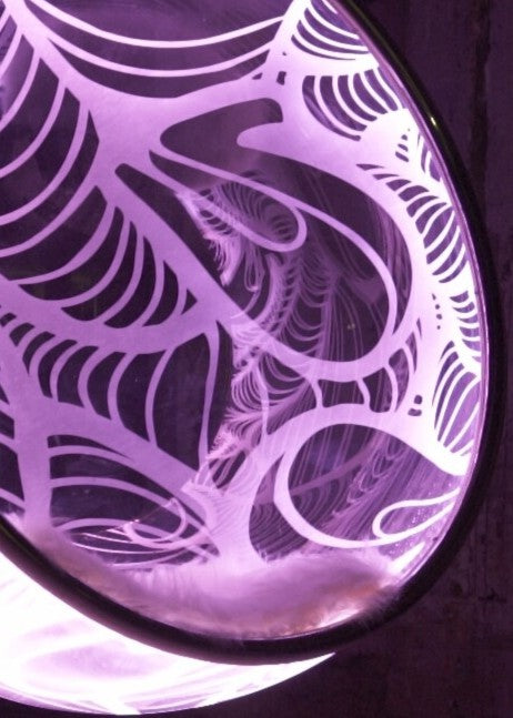 Ben Rousseau, Illuminated Bubble Chair – a limited-edition hanging sphere with engraved acrylic, vibrant pink-purple LED glow, and Mongolian sheepskin cushion featuring INSA’s signature pattern. A cocoon-like statement chair blending art, comfort, and sensory light.